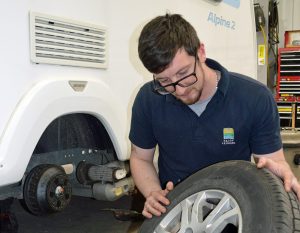 Josh Roberts inspecting wheel