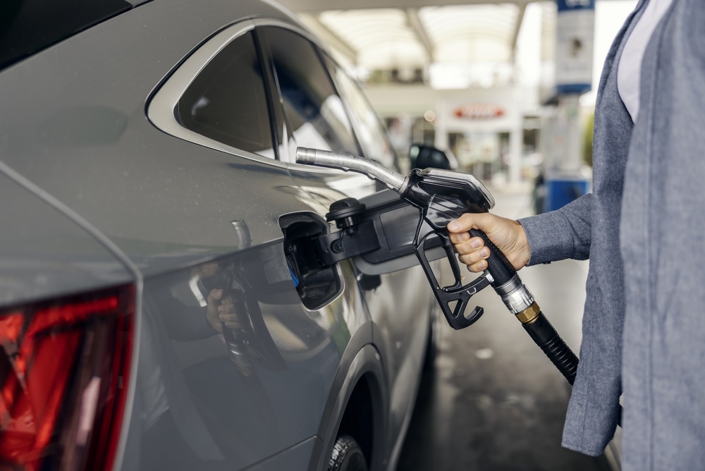 Person's,Hand,Holding,A,Fuel,Nozzle,,Inserting,It,Into,A